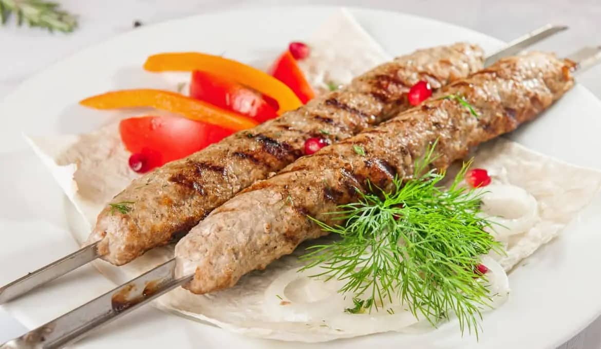 приготовленные на углях шампура из фарша баранины с курдюком, луком и традиционными кавказскими специями. подаётся с тонким лавашом, свежими овощами и зеленью